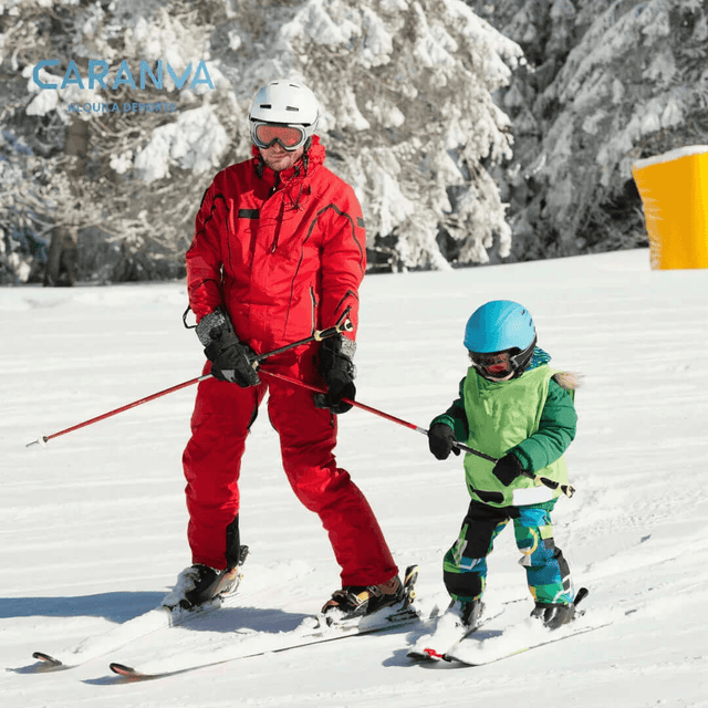 Child learning to ski with an instructor
